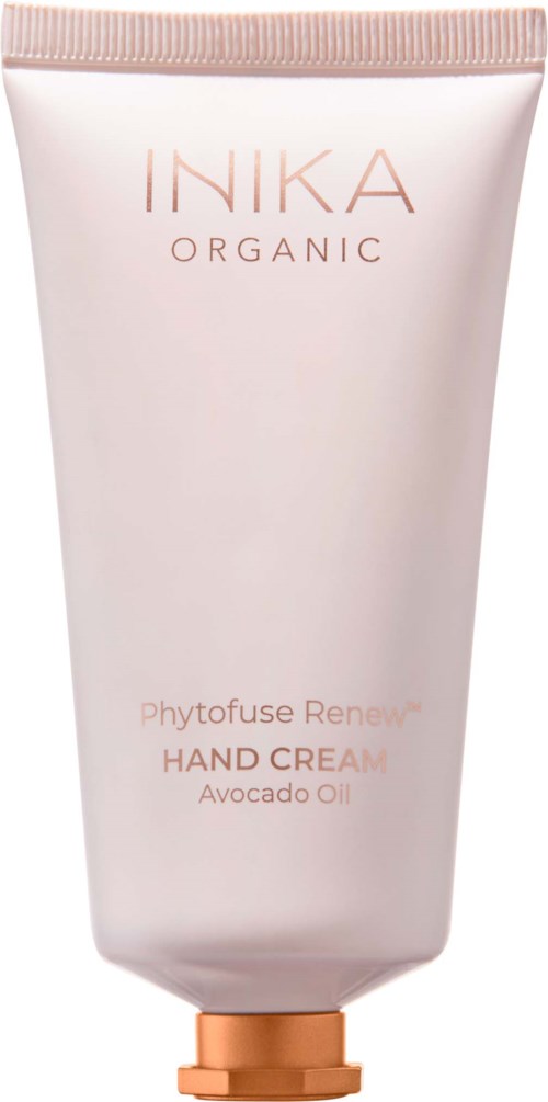 A soft pink tube of IIKA organic hand cream with avocado oil, standing upright with a rose gold cap.