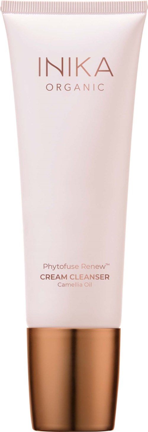 En tube av Inika Organic Phytofuse Renew Cream Cleanser med gullkork, lys rosa farge og enkel tekst.