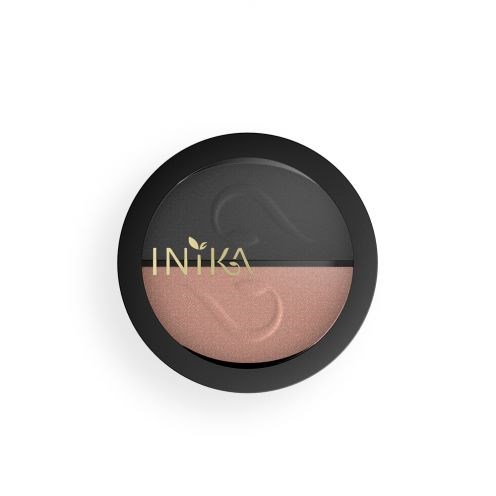 En rund behållare med dubbla färgade makeup, svart utvändigt, rosa och svart inuti, visar märket INIKA med en bladlogga.