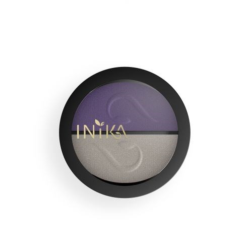 Bilden visar en rund behållare med lila och beige sektioner delade av en svart kant, med ordet INIKA på.