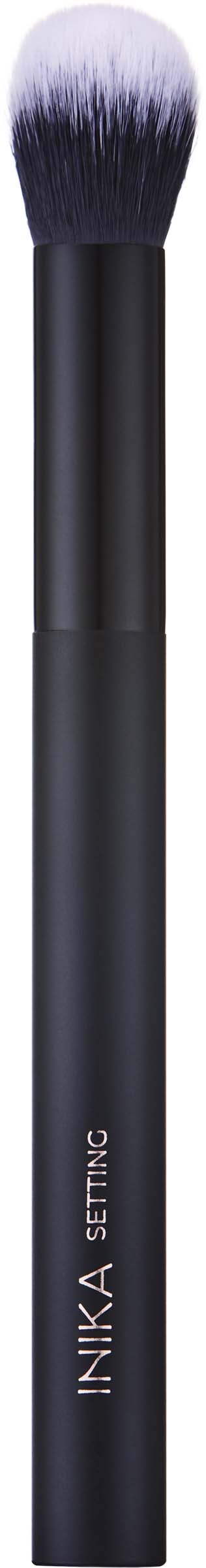 A makeup brush with a black handle and white-tipped bristles, used for applying powder or blush.