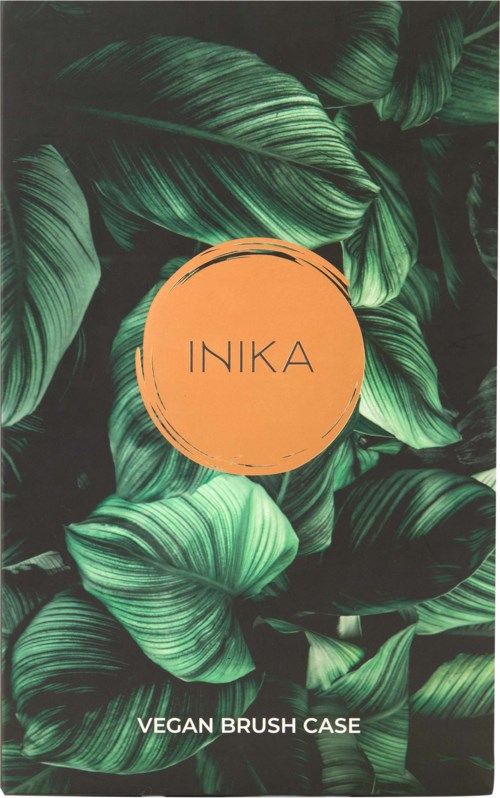 A green leafy background with an orange circle and the text 'INIKA' and 'VEGAN BRUSH CASE'.