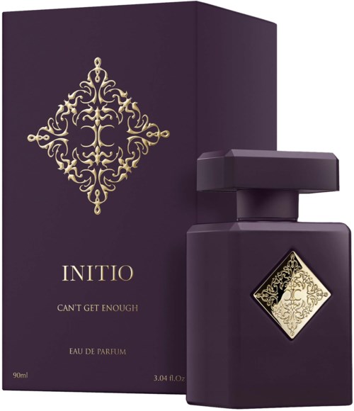 Dark purple perfume box and bottle with gold decorative design and label, labeled 'INITIO CAN'T GET ENOUGH'.
