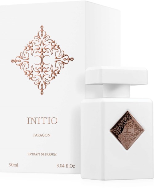Biała butelka perfum z ozdobnym brązowym wzorem obok pasującego eleganckiego opakowania.