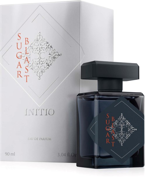 En parfymeflaske og eske med dekorativt design og rød tekst som sier Sugar Blast, i elegant stil.