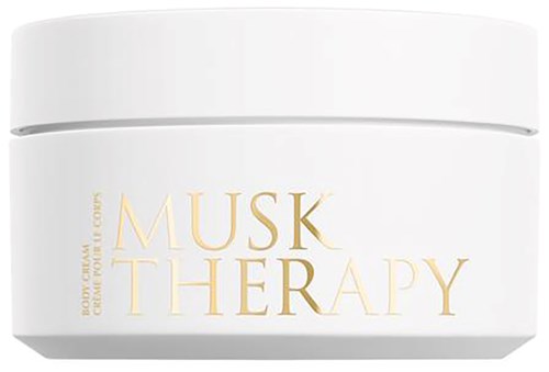 Biała kula z napisem 'Musk Therapy' w złotym kolorze, prawdopodobnie jest to krem do ciała.