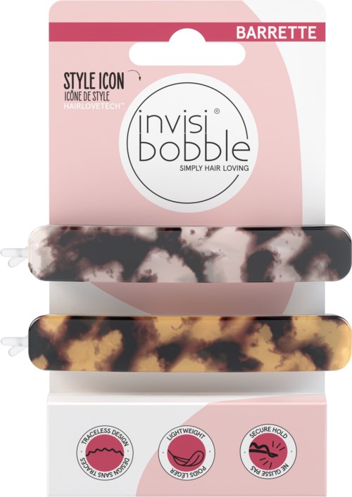Två hårspännen med djurmönster på ett rosa och vitt paket. Packningen säger 'invisibobble' och 'barrette.'