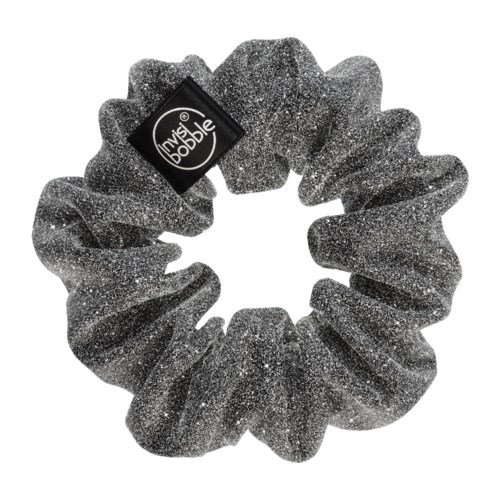 A sparkly black hairband with a small tag that says 'Invisibobble.'