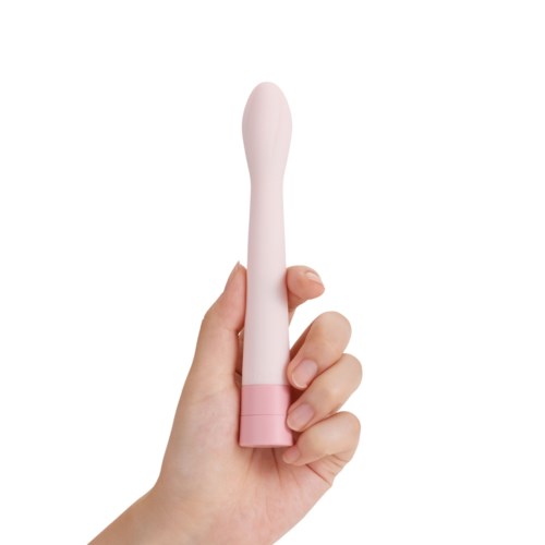 En hånd holder en rosa, bøyd, staveformet ting med en kule i enden.