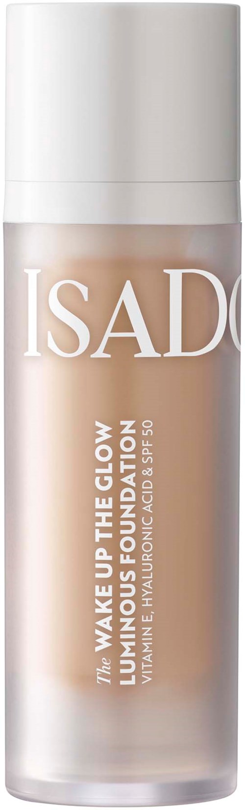 En høj hvid flaske mærket 'ISAD' til hudpleje, nævner glød og foundation, med tekst om vitaminer, hyaluronsyre og SPF.
