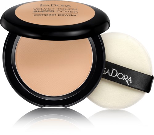 En kompakt puder i beige nyans, med en mjuk svamp. Kompakten är svart med ett genomskinligt lock.