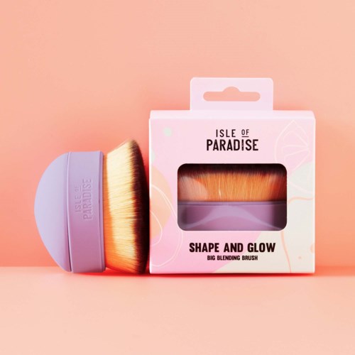 Ein Make-up-Pinsel und eine Schachtel mit der Aufschrift 'Shape and Glow' von Isle of Paradise. Der Pinsel hat einen lila Griff und orange Borsten.