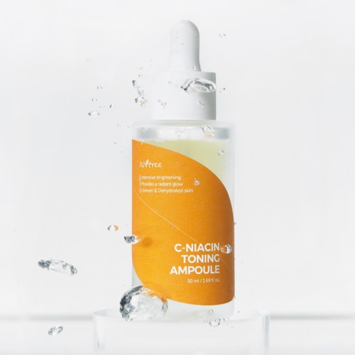 A skincare bottle labeled 'C-Niacin Toning Ampoule' with water splashes around it.