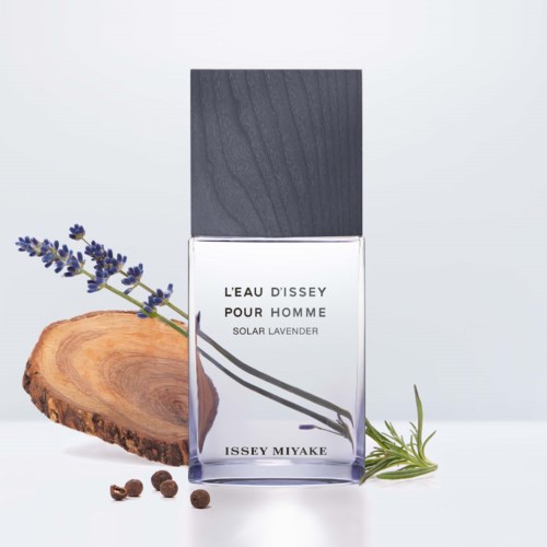 A perfume bottle labeled "L'Eau D'Issey Pour Homme" with lavender, rosemary, and wood elements nearby.