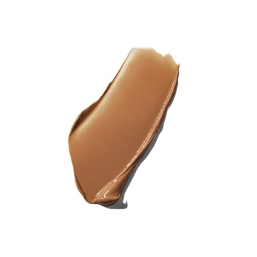 A smooth, caramel-colored substance spread on a white background, shaped irregularly.