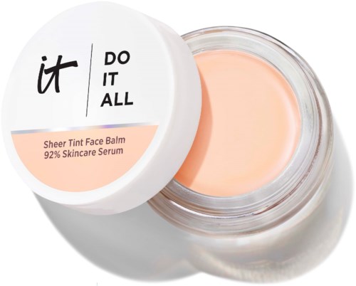 Åpne krukke med Sheer Tint Face Balm med lys lakserosa balm inni. Hvit lokk med svart og lyse korallfarget tekst.