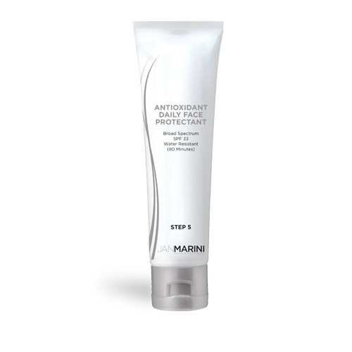 En vit tub med ansiktskyddscreme, märkt som antioxidant daglig ansiktsbeskydd med SPF 33, vattenavvisande och märkt Jan Marini.
