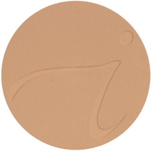 Ett runt brunt föremål med en liten cirkel och ljusa märken eller handstil på.