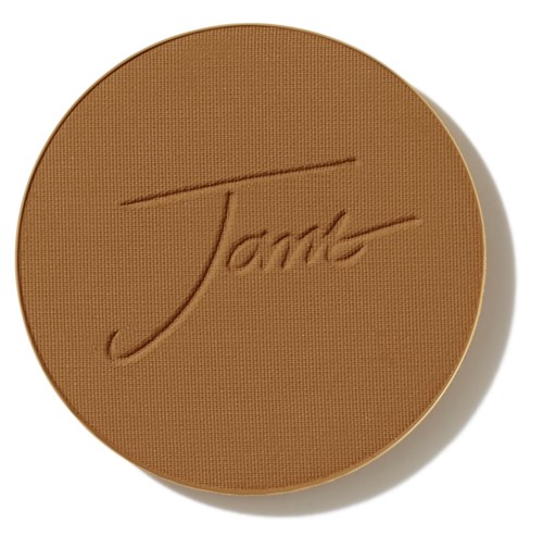 A round brown baked good with the word "Tarte" engraved on it.