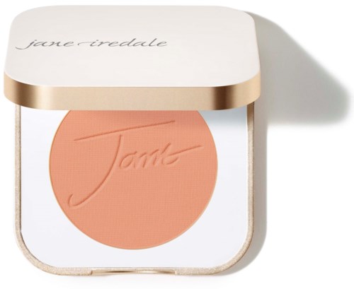 A compact with peach-colored blush and a white and gold lid, labeled 'Jane Iredale.'