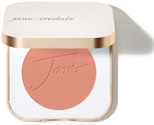 A makeup blush compact with a peach-colored blush and a white cover with gold edges. The cover has the brand name.