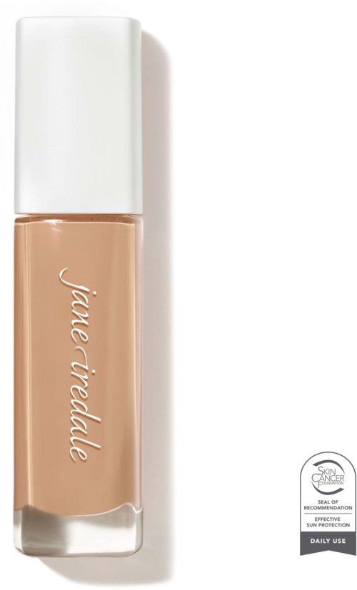 En beige makeup-blekningsflaska med vit lock och rosa text, rekommenderad för dagligt bruk.