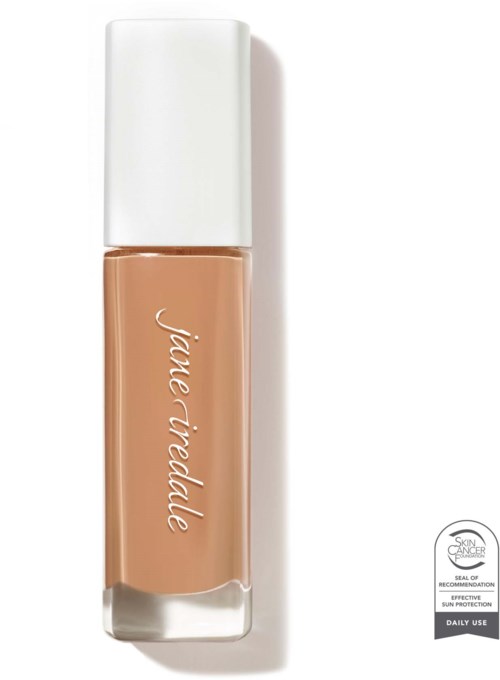 A makeup bottle with a white cap and beige liquid inside, labeled with brand name 'jane iredale'.