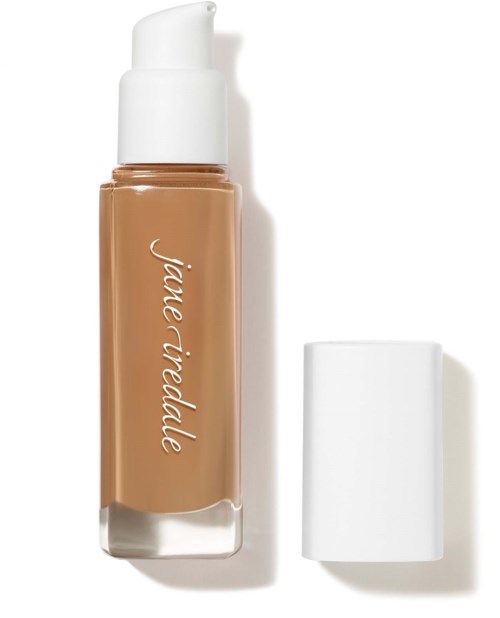 A beige liquid concealer bottle with a white cap and a pump dispenser.