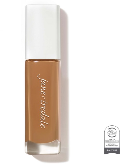 A bottle of brand makeup concealer with white cap, beige liquid inside, and brand name written on it.