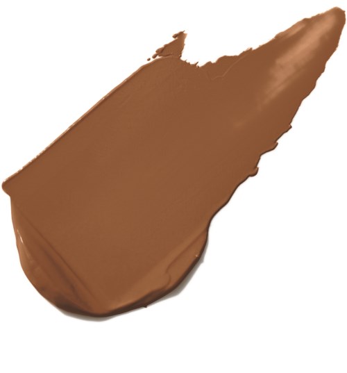 En klick formad jordnötssmör på en vit bakgrund.