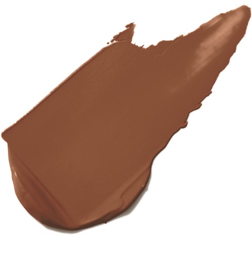 En klick av brun kräm eller chokladsås med spetsig ände och slät yta.
