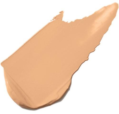 Ett klick av beige foundations- eller concealer-kräm med en slät, krämig textur på en vit bakgrund.