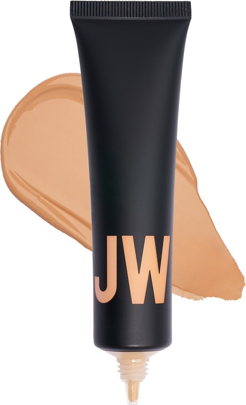 En svart tube med "JW" på, og beige foundation rundt den.