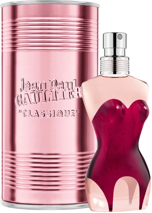 Ein Parfümflasche in Frauenkörperform mit rotem Kleid-Design, und eine rosa Dose mit geprägtem Text.