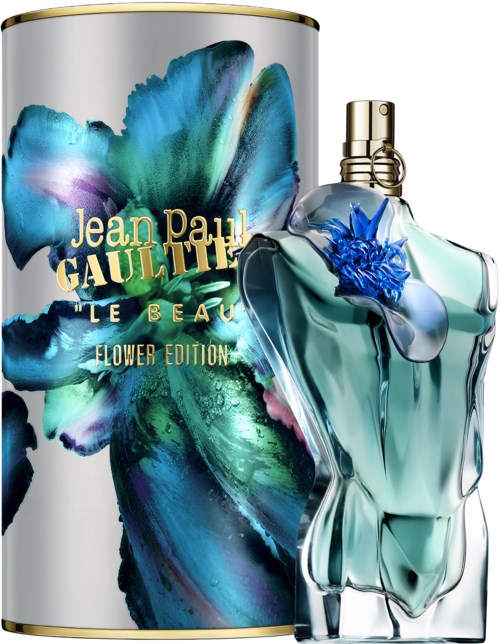 Een parfumbottle in de vorm van een vrouwelijk lichaam en een bloemendesign, samen met een grote, kleurrijke cilindervormige doos.