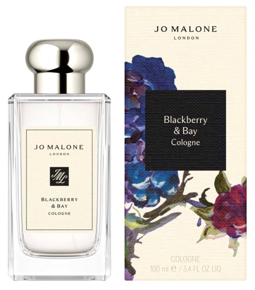 A perfume bottle with a silver cap next to a floral box for Blackberry & Bay cologne by Jo Malone.