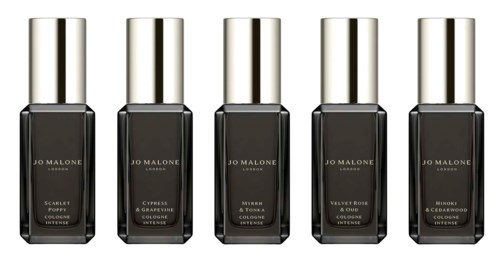Five nail polish bottles lined up, each with a silver cap and black body, different names and colors on labels.