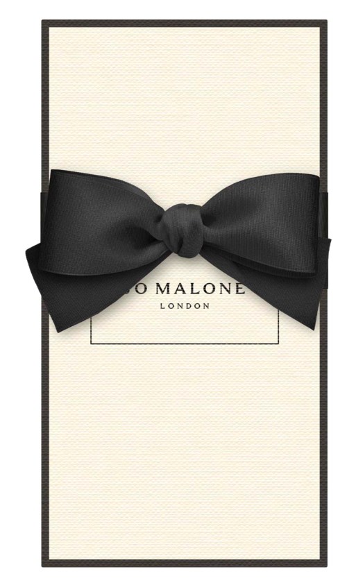 A cream-colored box with a black border, tied with a large black bow. The label says "O MALONE LONDON".