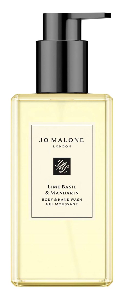 A transparent bottle with a black pump, containing a light yellow body and hand wash labeled Lime Basil & Mandarin.