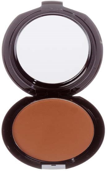 A compact with a large mirror and brown makeup inside.