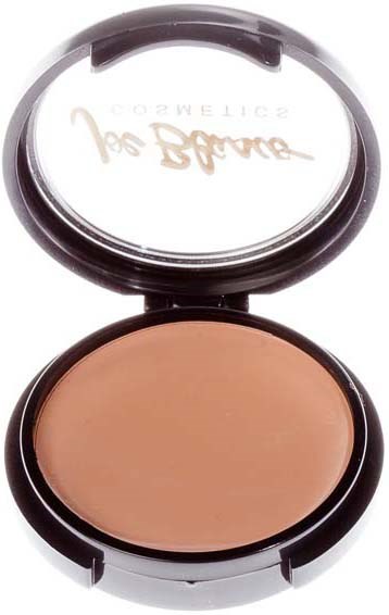A compact makeup container with a beige powder inside and a mirror lid. The text on the mirror is reversed.