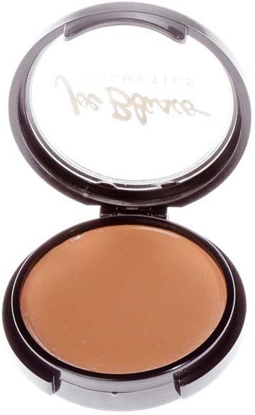 A compact makeup case with a mirror, containing beige foundation or concealer.