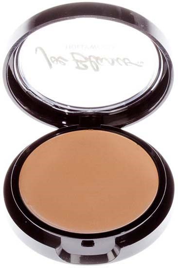 A compact with mirror and beige pressed powder, open lid shows handwriting on inside of the mirror.