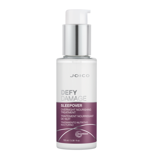 En vit flaska med pump märkt Joico Defy Damage Sleepover nattbehandling.