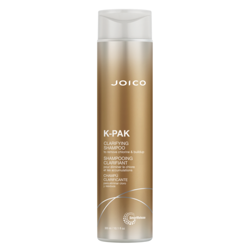 En lång, guldfärgad och vit schampoflaska märkt Joico K-Pak Clarifying Shampoo.