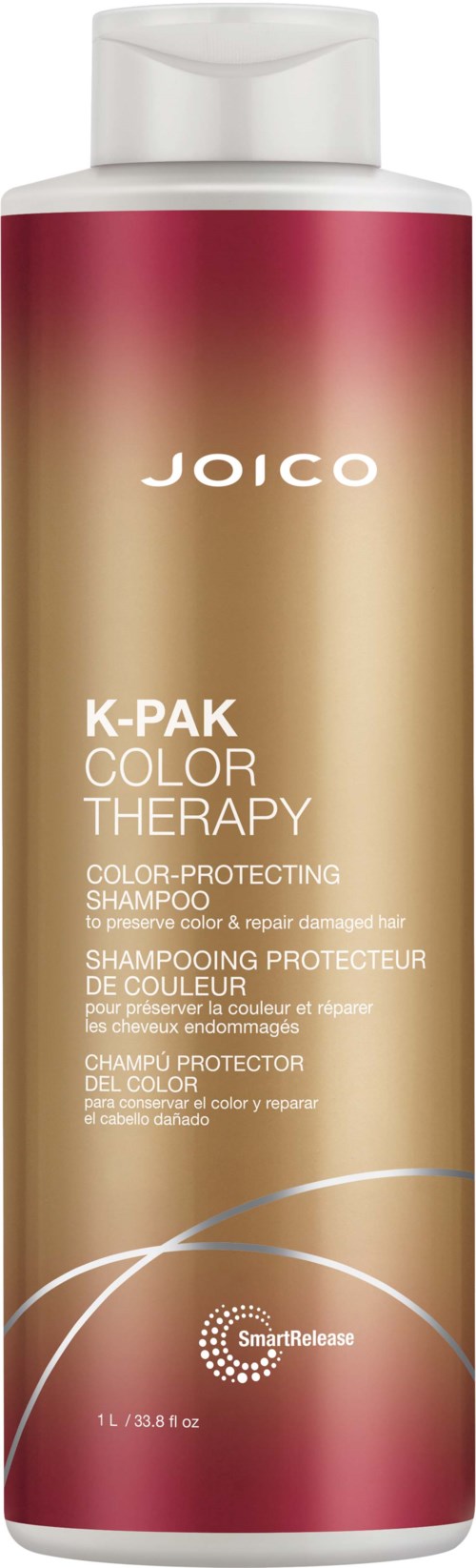 A tall, cylindrical shampoo bottle with a white cap, featuring a gradient from pink at the top to beige at the bottom, and the brand name Joico.