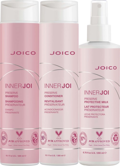 Tre rosa hårpleieflasker merket Inner Joi for å bevare, beskytte og revitalisere håret.