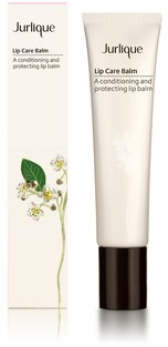 A white tube of Jurlique Lip Care Balm with a black cap, standing next to its packaging box.