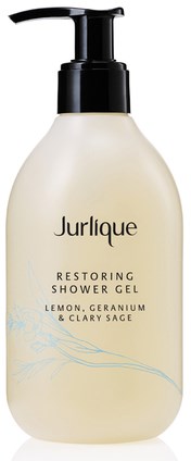 A white bottle with a black pump labeled Jurlique Restoring Shower Gel, lemon, geranium, and clary sage scents.