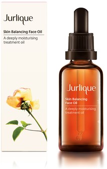 En brun flaske med pipette, merket 'Jurlique Skin Balancing Face Oil' og en gul blomst.